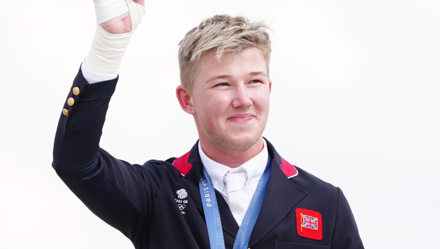 Great Britain's Harry Charles celebrates with their gold medal during the ceremony of the Jumping Team Final at the Chateau de Versailles on the seventh day of the 2024 Paris Olympic Games in France. Picture date: Friday August 2, 2024. (Photo by David Davies/PA Images via Getty Images)